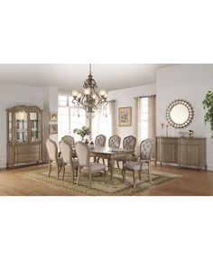 a dining room table with chairs and a chandelier