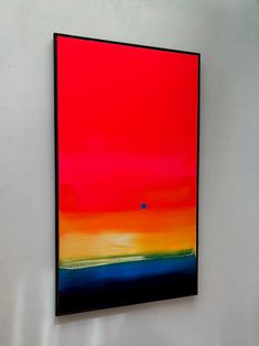 an abstract painting hangs on the wall