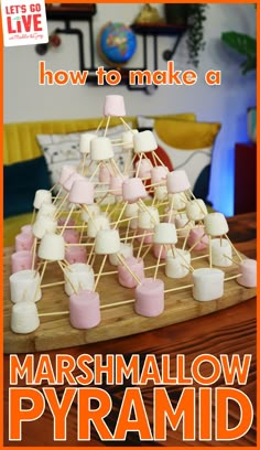 marshmallow pyramid on a wooden board with the words how to make a marshmallow pyramid