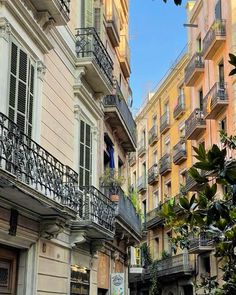 an alleyway in the city with buildings and balconies