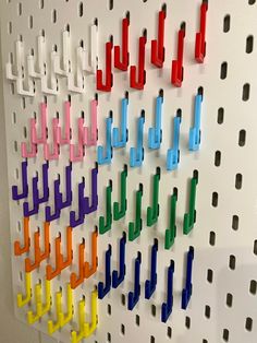 the colorful pegs are hanging on the wall