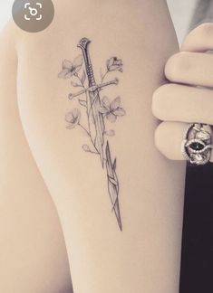 Hadhafang Tattoo, Lotr Flowers Tattoo, Feminine Lotr Tattoo, Narsil Tattoo With Flowers, Lotr Spine Tattoo, Lowkey Tattoos, Small Lord Of The Rings Tattoo, Dainty Dagger Tattoo, Eowyn Tattoo