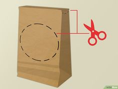 a brown paper bag with a pair of red scissors on it and a hole cut in the side