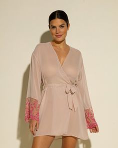 Sheer robe with lace sleeves. Beautifully detailed rigid semi-sheer lace. Mid-thigh length. Removable tie at waist. Lace trimmed long sleeves. Hand wash, do not dry in dryer. Long Sleeve Lace Sleepwear For Loungewear, Long Sleeve Lace Sleepwear For Lounge, Spring Sheer Long Sleeve Kimono, Elegant Long Sleeve Sheer Sleepwear, Elegant Long Sleeve Lace Sleepwear, Feminine Long Sleeve Kimono For Loungewear, Sheer Long Sleeve Robe For Wedding Night, Lace Trim Long Sleeve Sleepwear, Sheer Long Sleeve Sleepwear For Spring