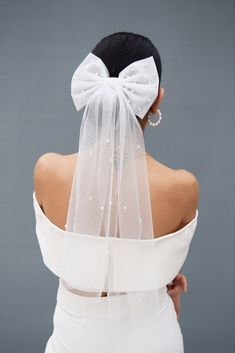 the back of a woman wearing a white wedding veil