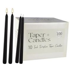 two black candles sitting next to each other in front of a box with the words paper candles on it