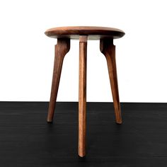 a small wooden table sitting on top of a hard wood floor