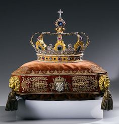 an ornate crown sits on display with tassels