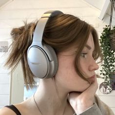 a woman with headphones on her ears