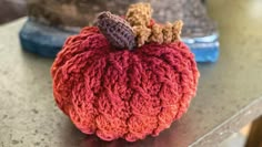 a crocheted pumpkin sitting on top of a table