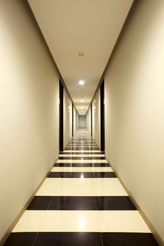 an empty hallway with black and white striped floors