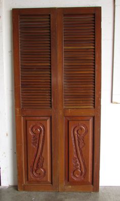 two wooden doors with carved designs on them