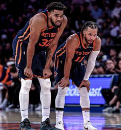 two basketball players standing next to each other on a court