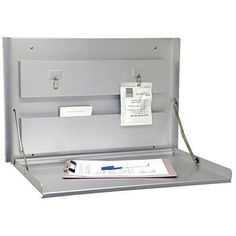 an open metal box with some papers on it and a clipboard attached to the lid