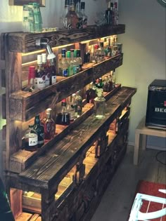 an old pallet is filled with liquor bottles and jars on it's shelves