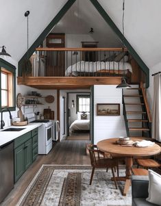 a kitchen and living room are separated by a loft