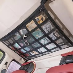 the inside of a vehicle with several items in it's back pocket and hanging from the ceiling