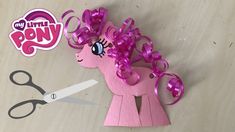 a pink pony cut out with scissors on the table