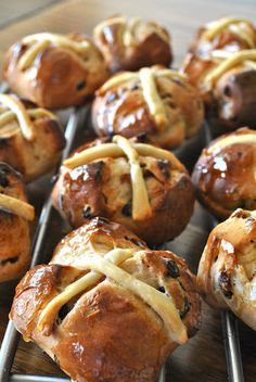 freshly baked hot cross buns are cooling on a rack, ready to be eaten