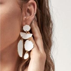 White Dangle Drop Earrings Trendy White Metal Earrings, Trendy Single White Earring, Trendy White Single Earring, White Metal Dangle Linear Earrings, Trendy White Drop Earrings, Elegant White Metal Chandelier Earrings, Chic White Metal Earrings, White Metal Chandelier Earrings For Pierced Ears, Single White Metal Earring