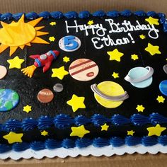 a birthday cake decorated with space and stars