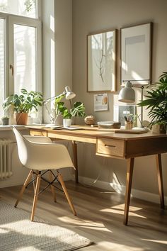 a desk with some plants and pictures on the wall next to it in front of a window