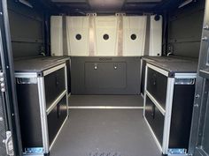 the interior of an empty van with chrome trim and stainless steel appliances on the doors