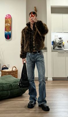 a man standing in a living room wearing a fur coat and holding a handbag