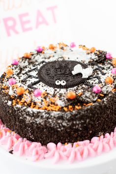 a chocolate cake with sprinkles and an oreo cookie on the top