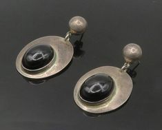 "MEXICO 925 Sterling Silver - Vintage Black Onyx Oval Dangle Earrings - EG8801  MEXICO 925 Sterling Silver - Vintage Black Onyx Oval Dangle Earrings - EG8801  Jewelry Type:         Earrings   Metal Type:            925 Silver   Metal Size:             1.75\"  Stone Type:            Onyx   Condition:              N/A  Jewelry Weight:     18.3 Grams  PLEASE NOTE: THIS ITEM IS PRE-OWNED. ALTHOUGH MOST ITEMS ARE IN VERY GOOD CONDITION, SOME MAY NEED CLEANING AND/OR MINOR REPAIRS. WE MAKE A VERY STRONG EFFORT TO UPLOAD CLEAR PICTURES. PLEASE INSPECT ALL PICTURES AND ASK ALL QUESTIONS YOU MAY HAVE PRIOR TO MAKING A PURCHASE. NOT ALL STONES ARE GENUINE, SOME ARE ENHANCED OR CREATED." Earrings Metal, Black Onyx, Types Of Metal, Vintage Black, Metallic Silver, Onyx, 925 Silver, Dangle Earrings, Jewelry Earrings