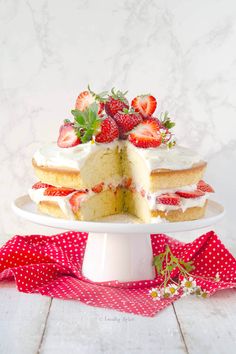 a white cake with strawberries on top