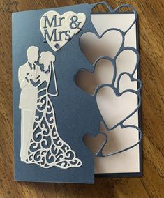 a wedding card with a cutout of a bride and groom