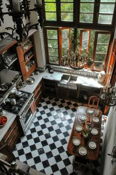 an old fashioned kitchen with black and white checkerboard flooring, wooden cabinets and windows