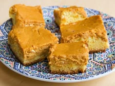 several pieces of cake on a blue and white plate