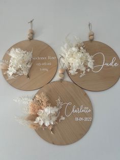 three personalized wooden plaques with flowers on them