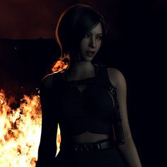 a woman standing in front of a fire with her hands on her hips and looking at the camera