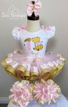 a pink and gold winnie the pooh birthday outfit