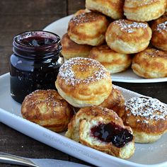 several pastries are stacked on a plate with jam