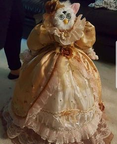 a white cat sitting on top of a dress