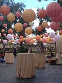 many paper lanterns are hanging from the ceiling