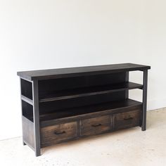 an entertainment center with two drawers on each side and a shelf below it for storage