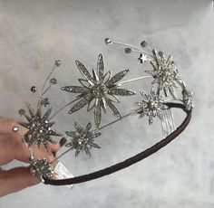 This tiara is beautifully silver-plated and encrusted with sparkling clear genuine zirconium stones of various sizes in Star shapes. The many zirconium Stones make this crown sparkle in any light and are prong set by hands! This piece is versatile and compliments many different styles, can be worn for Weddings, Bridal Showers, Birthdays, Baby Showers, Graduation, Maternity Shoots or any special occasions! Handmade Star and CelestialTiaras/Crown Made to Order Diamond Weight -- 14.64ct Diamond -- Pretty Wedding Rings, Handmade Tiaras, Maternity Shoots, Beautiful Hair Accessories, Crown Tiara, Diamond Crown, Zircon Jewelry, Sterling Silver Brooch, Hair Accessories Jewelry