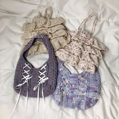 three crocheted purses laying on top of a white bed next to each other