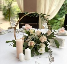 a white table with candles and flowers on it