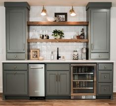 a kitchen with gray cabinets and silver appliances