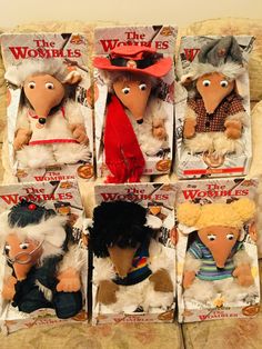 six stuffed animals are in the same package as one is wearing a hat and another has an eye patch