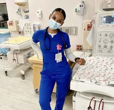 a woman in scrubs stands next to a hospital bed