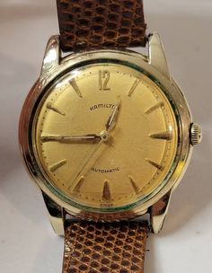 Hi Buyers You are buying a Vintage 1960s Hamilton 10KGF 35mm 17 Jewel Automatic Swiss Cal.672 Men's Watch. Pre-owned in good conditions, see pictures for more details as they are part of my description. This watch is working great and keeping time in the last 48 hours. Features all yellow dial, arrow markers with 10K gold filled bezel, stainless steel case, push-pull crown, luminous hands. Buy with confidence as all my items are authentic. Follow me as I will be posting more treasures for you to Vintage Brown Watch For Anniversary, Vintage Brown Watch Accessories For Anniversary, Retro Automatic Watches For Formal Occasions, Vintage Automatic Watch For Formal Occasions, Vintage Automatic Watches For Formal Occasions, Vintage Self-winding Watch, Vintage Automatic Watch Accessories For Formal Occasions, Vintage Automatic Watches, Wristwatch Men