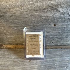 an image of a candle that is sitting on the ground in front of a wooden wall