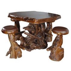 a wooden table and two stools with wood carvings on the top, against a white background